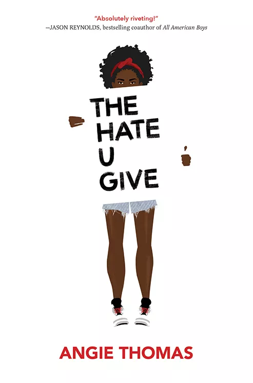 A black teenage girl with jean shorts, tennis shoes, and natural hair holding up a large sign with the title of the book 